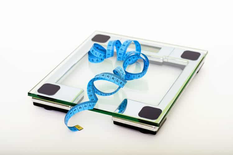 A picture of a weight scale and a measuring tape